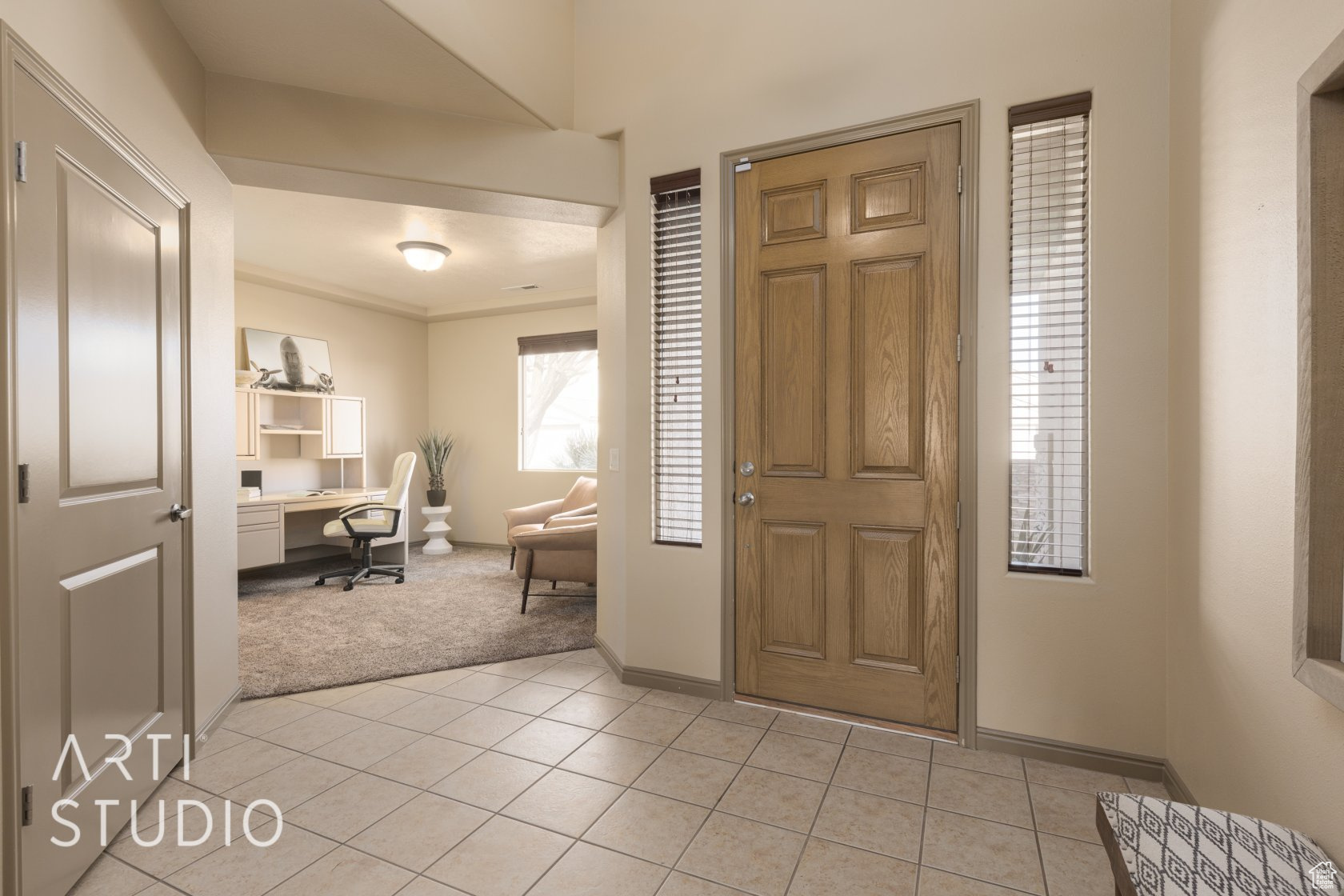 Foyer entrance with built in desk and light tile patterned floors