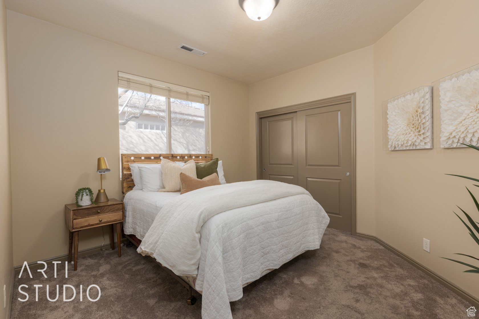 Carpeted bedroom featuring a closet