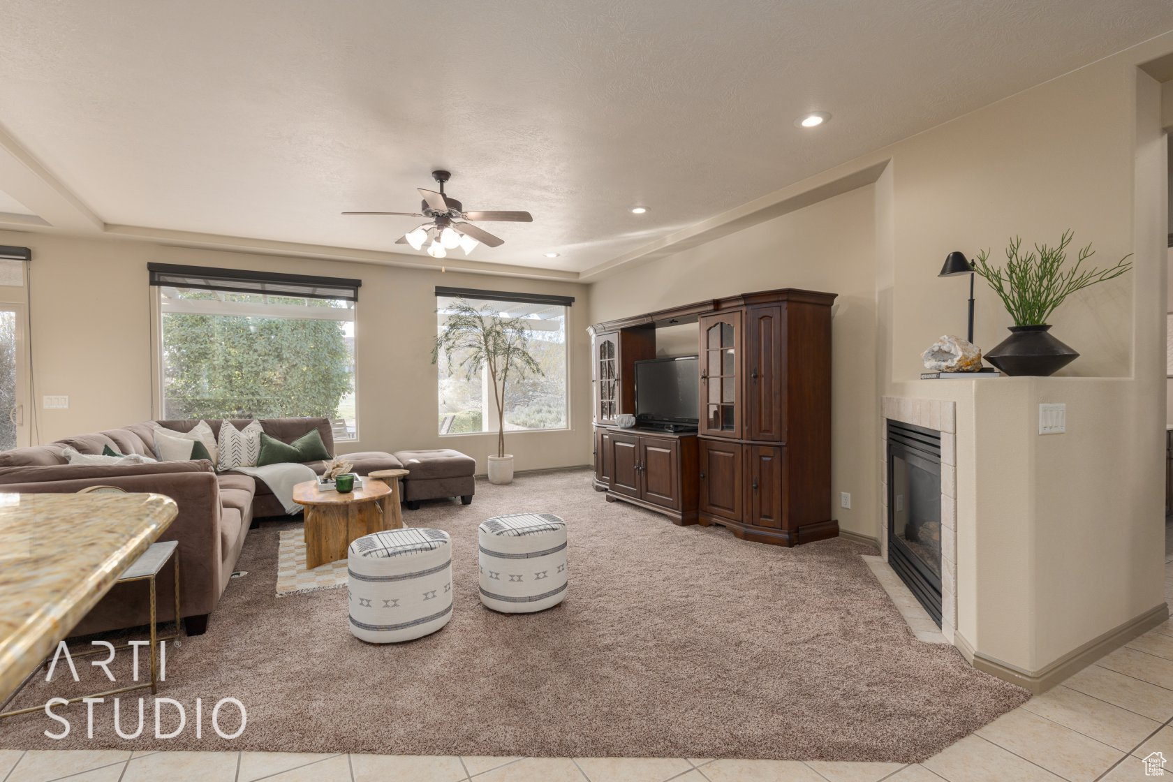 Living room with light colored carpet and ceiling fan