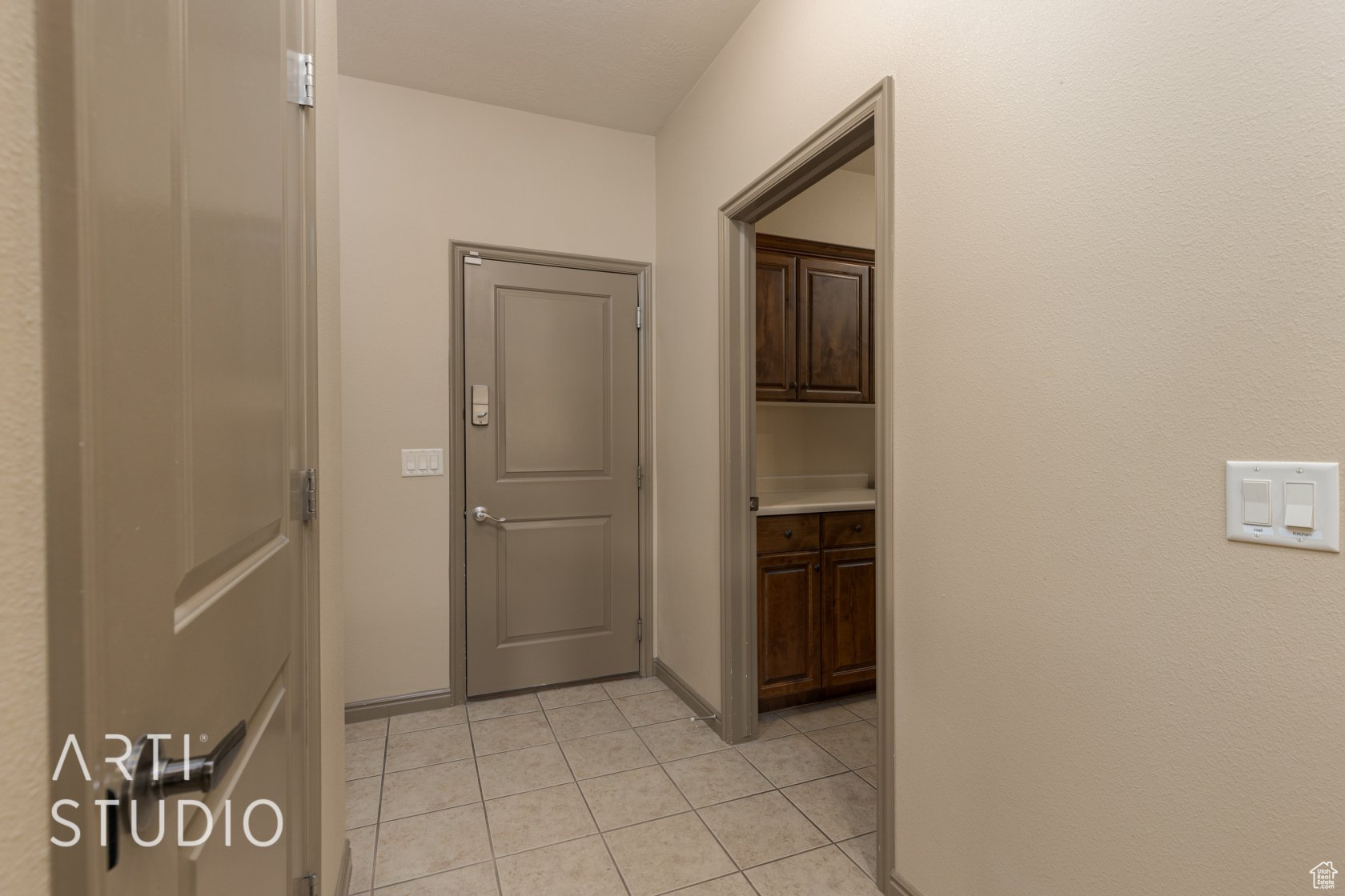 Corridor with light tile patterned flooring