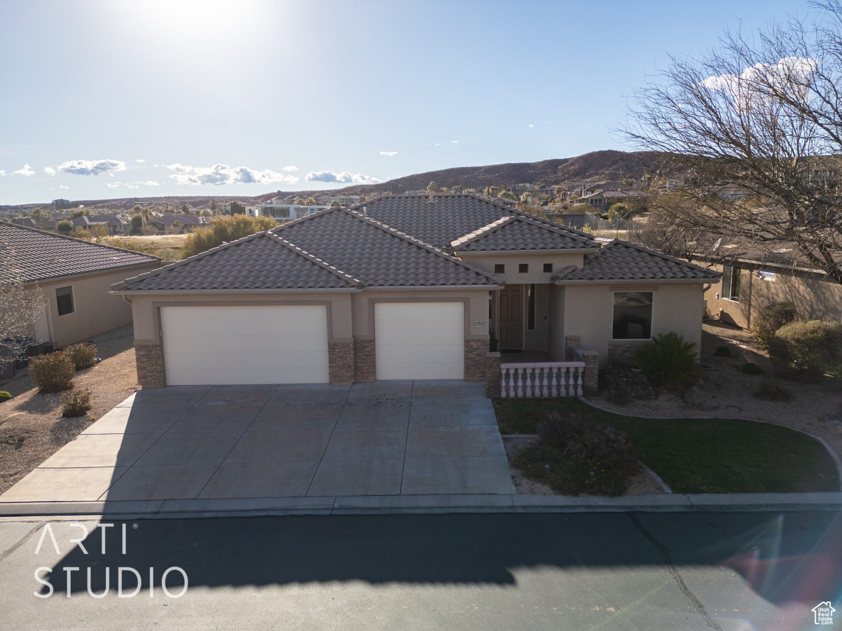 View of front of property featuring a mountain view and a garage