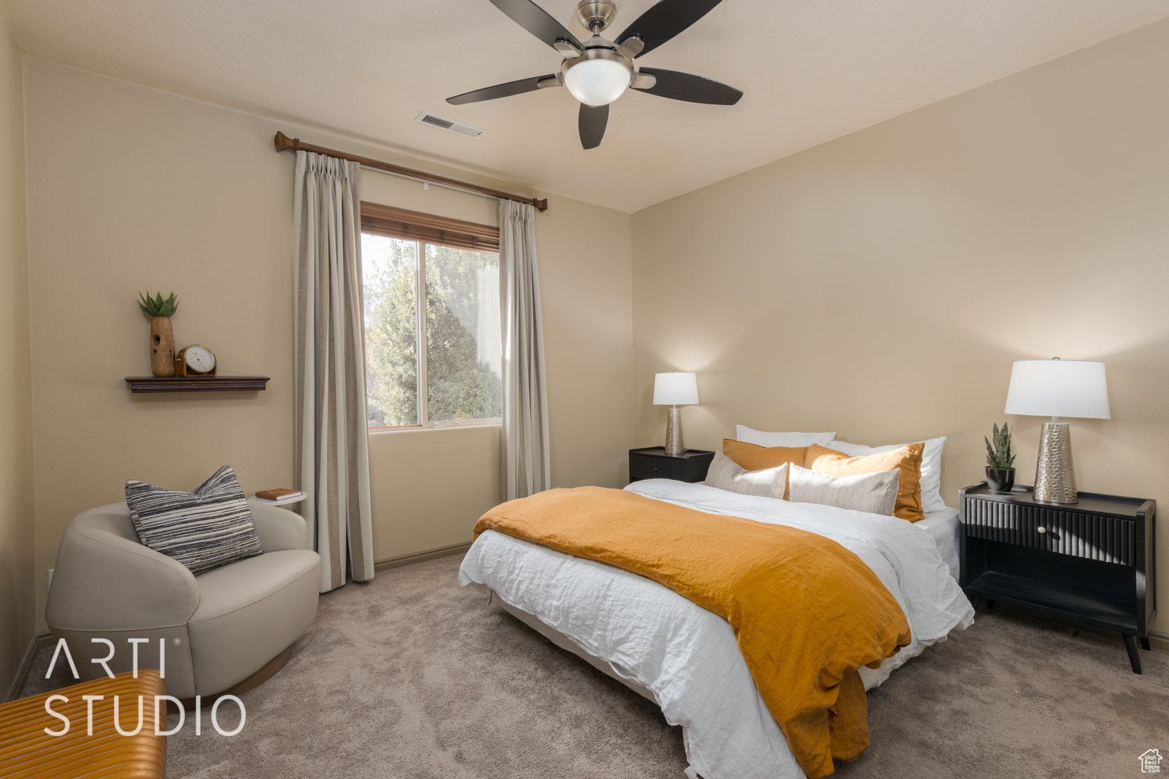 Carpeted bedroom with ceiling fan
