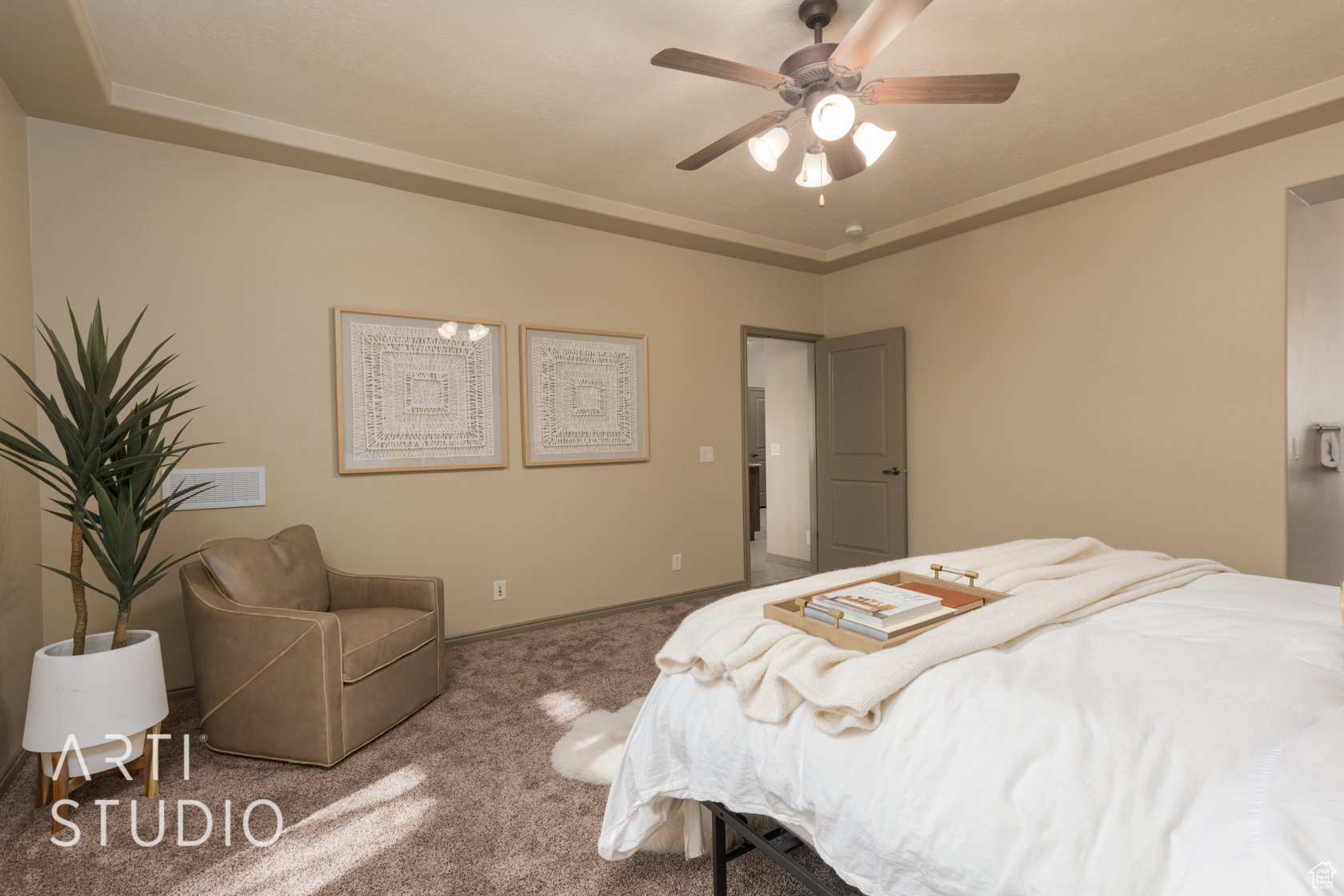Bedroom featuring a raised ceiling, carpet floors, and ceiling fan
