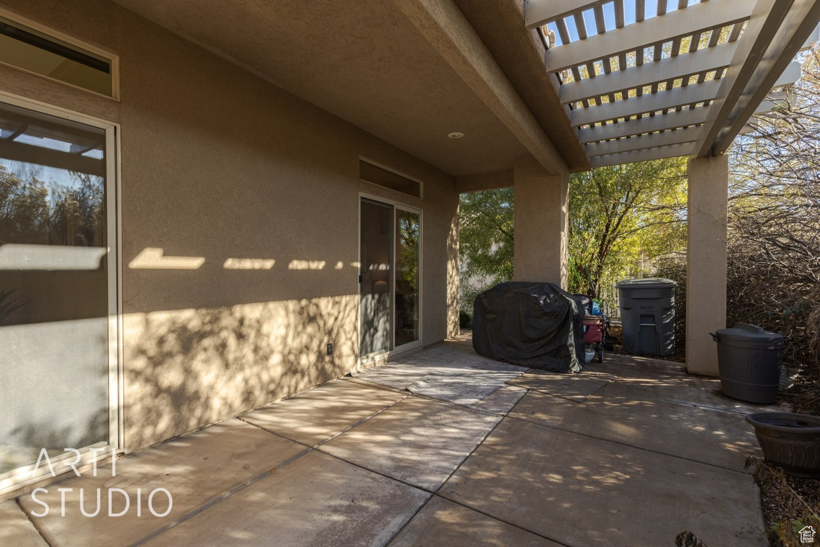 View of patio with a grill and a pergola