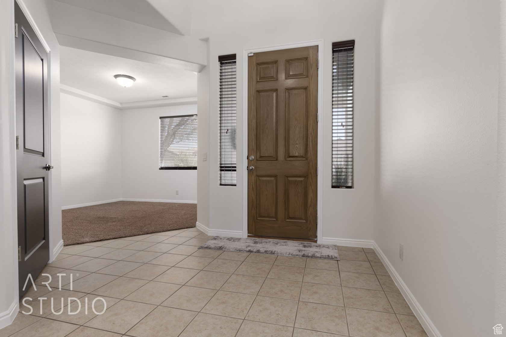 Entrance foyer with light tile patterned floors