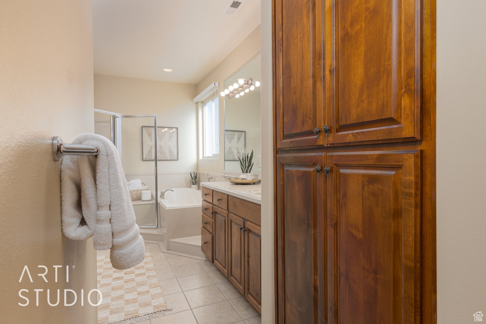 Bathroom with tile patterned floors, separate shower and tub, and vanity