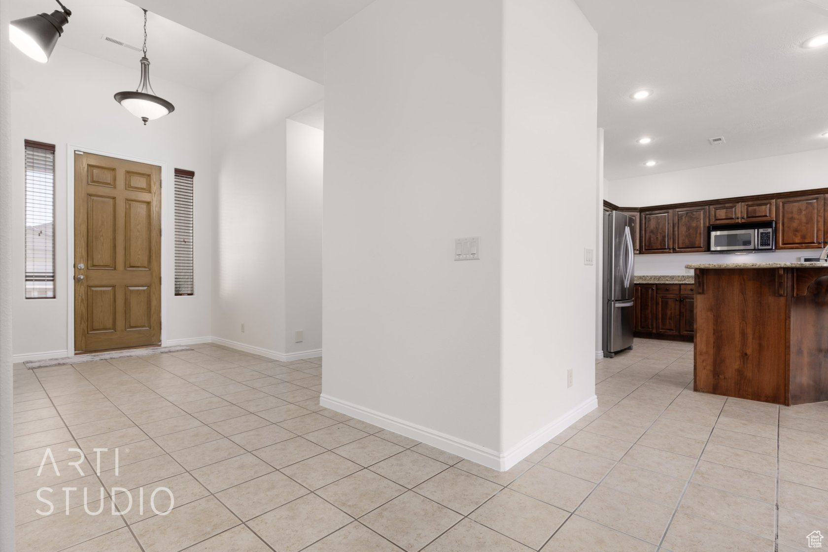 Foyer entrance with light tile patterned floors