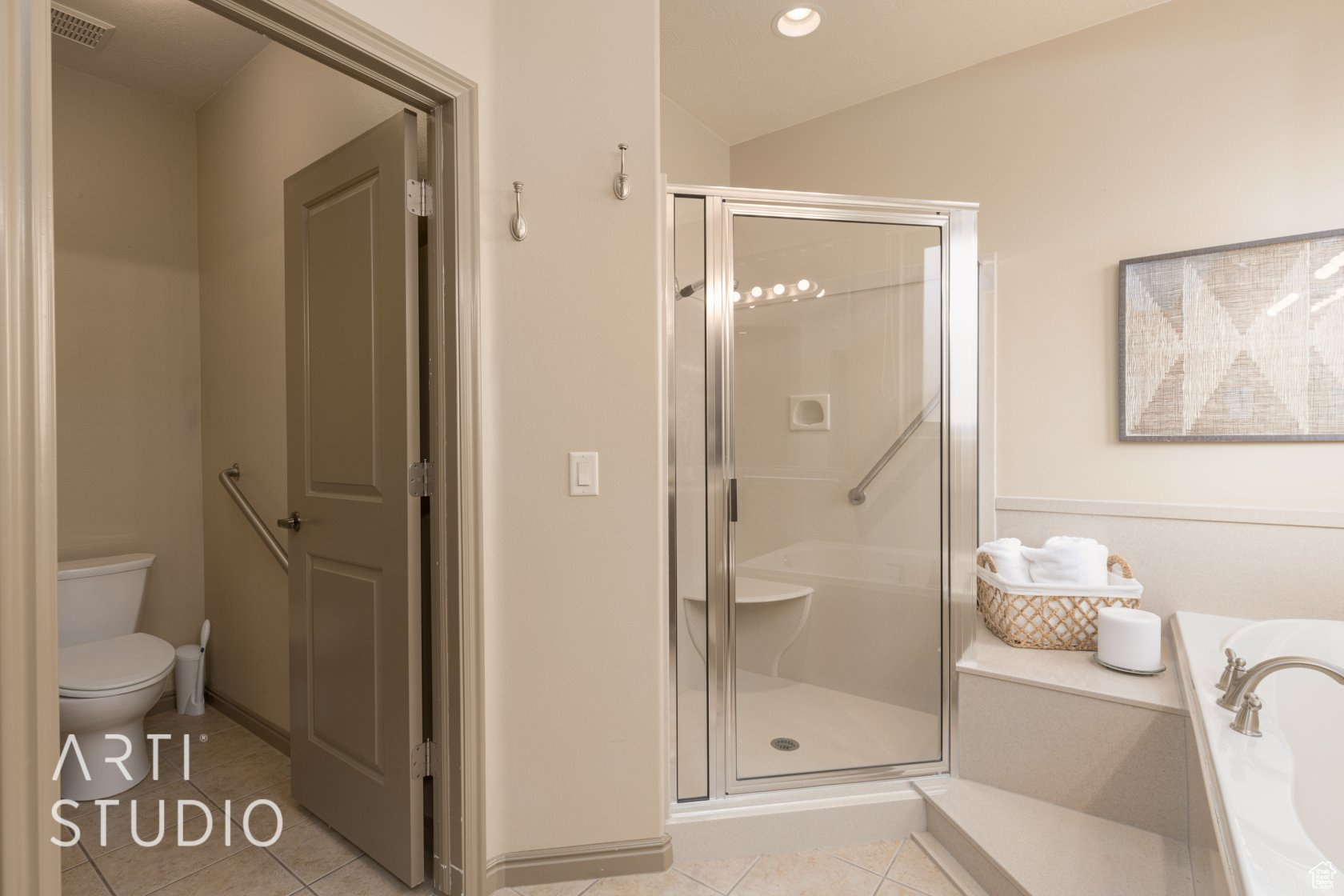 Bathroom featuring toilet, shower with separate bathtub, tile patterned flooring, and vaulted ceiling