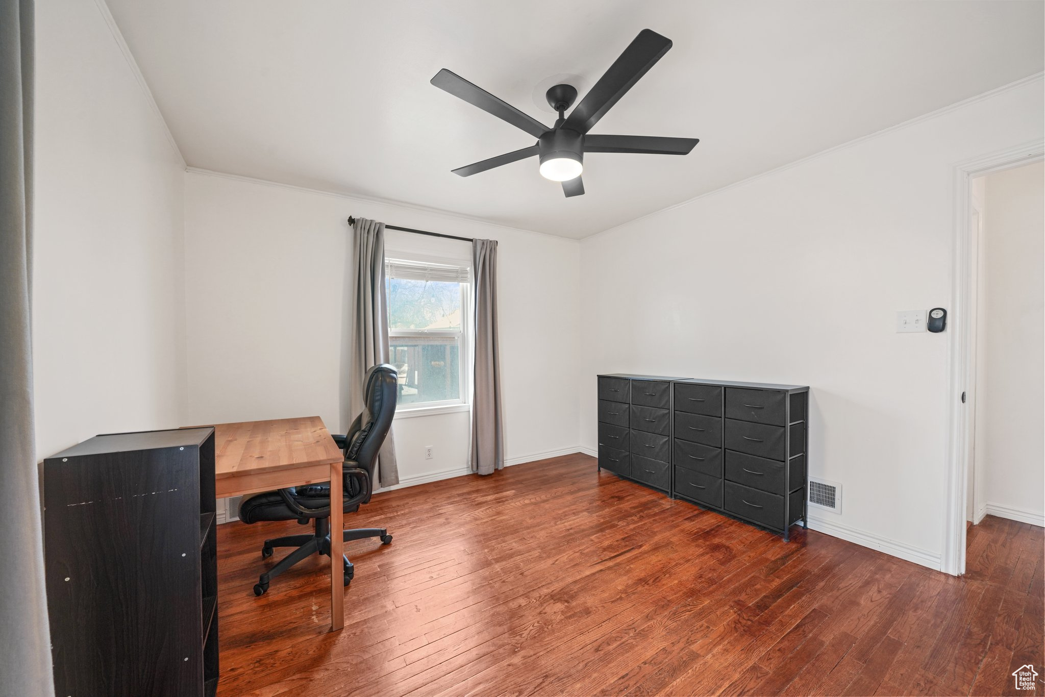 Office featuring dark wood-style floors, a ceiling fan, and baseboards