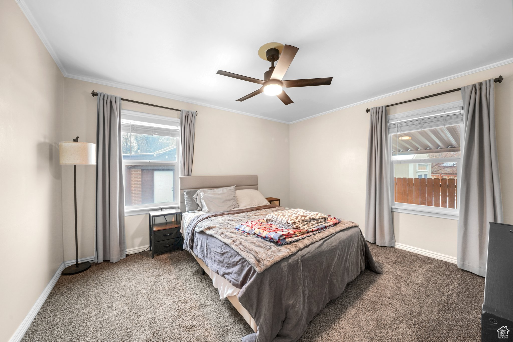 Bedroom featuring ornamental molding, carpet flooring, and baseboards
