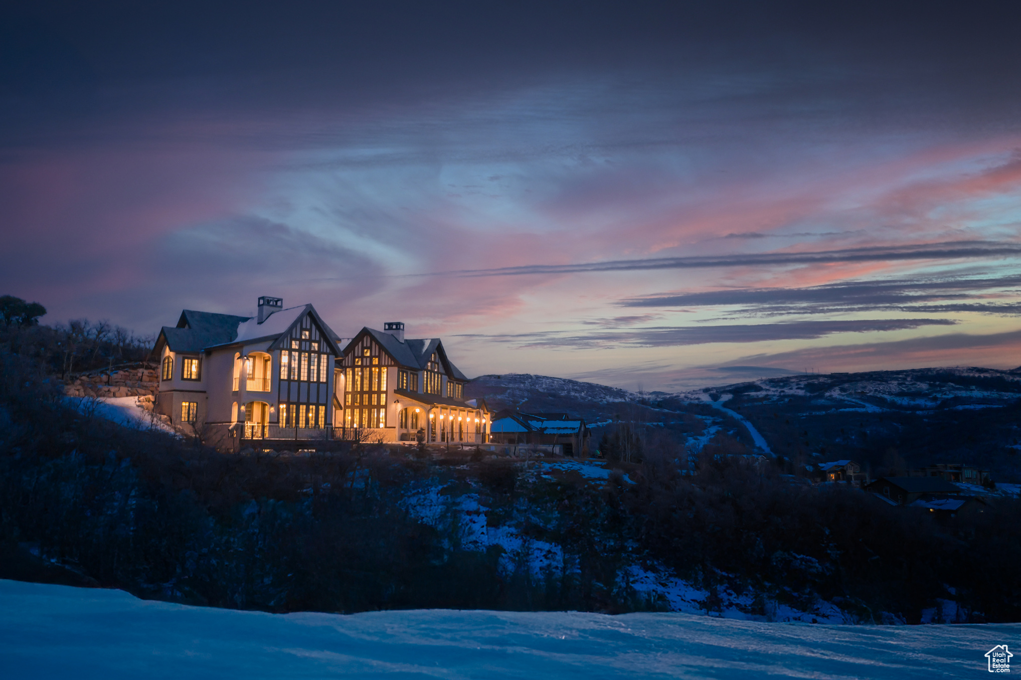 Snow covered house featuring a mountain view.