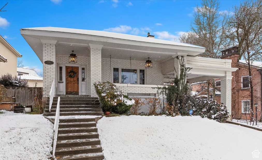 View of front of house featuring covered porch with glass lanterns, Sunday Porch Swing, and Porte Cochere