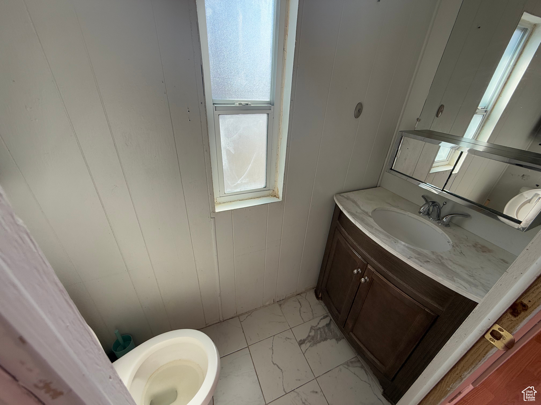 Bathroom with marble finish floor and vanity