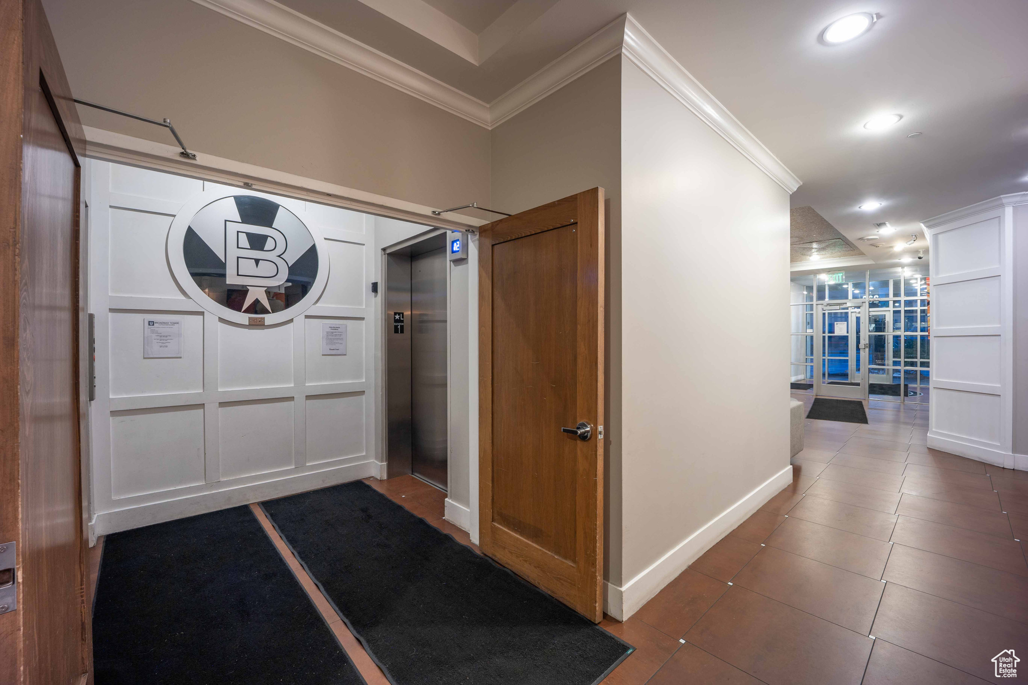 Foyer featuring recessed lighting, crown molding, dark tile patterned floors, baseboards, and elevator