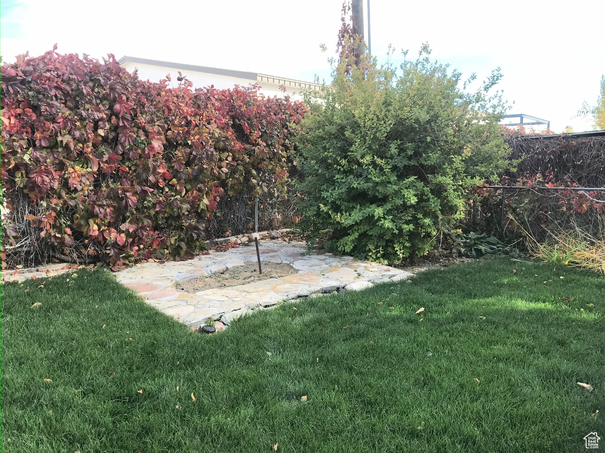 View of yard with fence and a patio