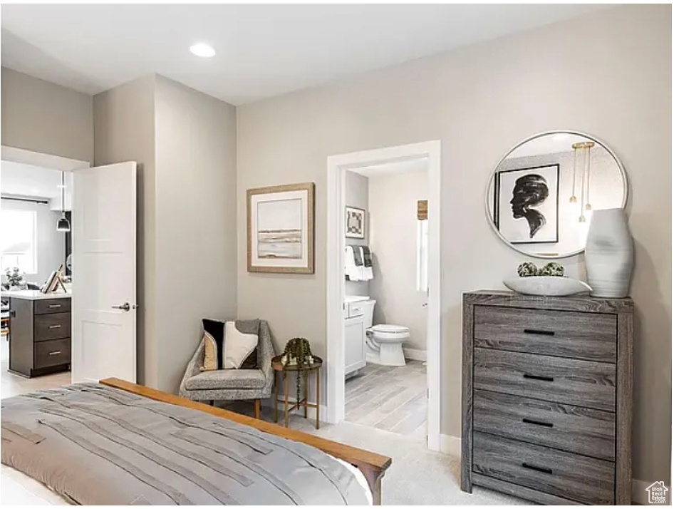 Bedroom with recessed lighting, baseboards, and ensuite bathroom