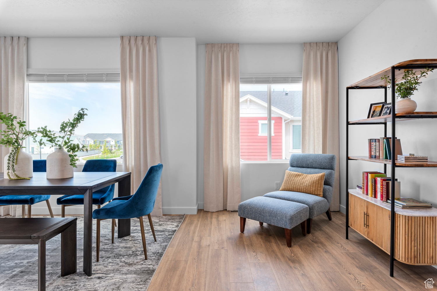 Interior space featuring a healthy amount of sunlight, baseboards, and wood finished floors