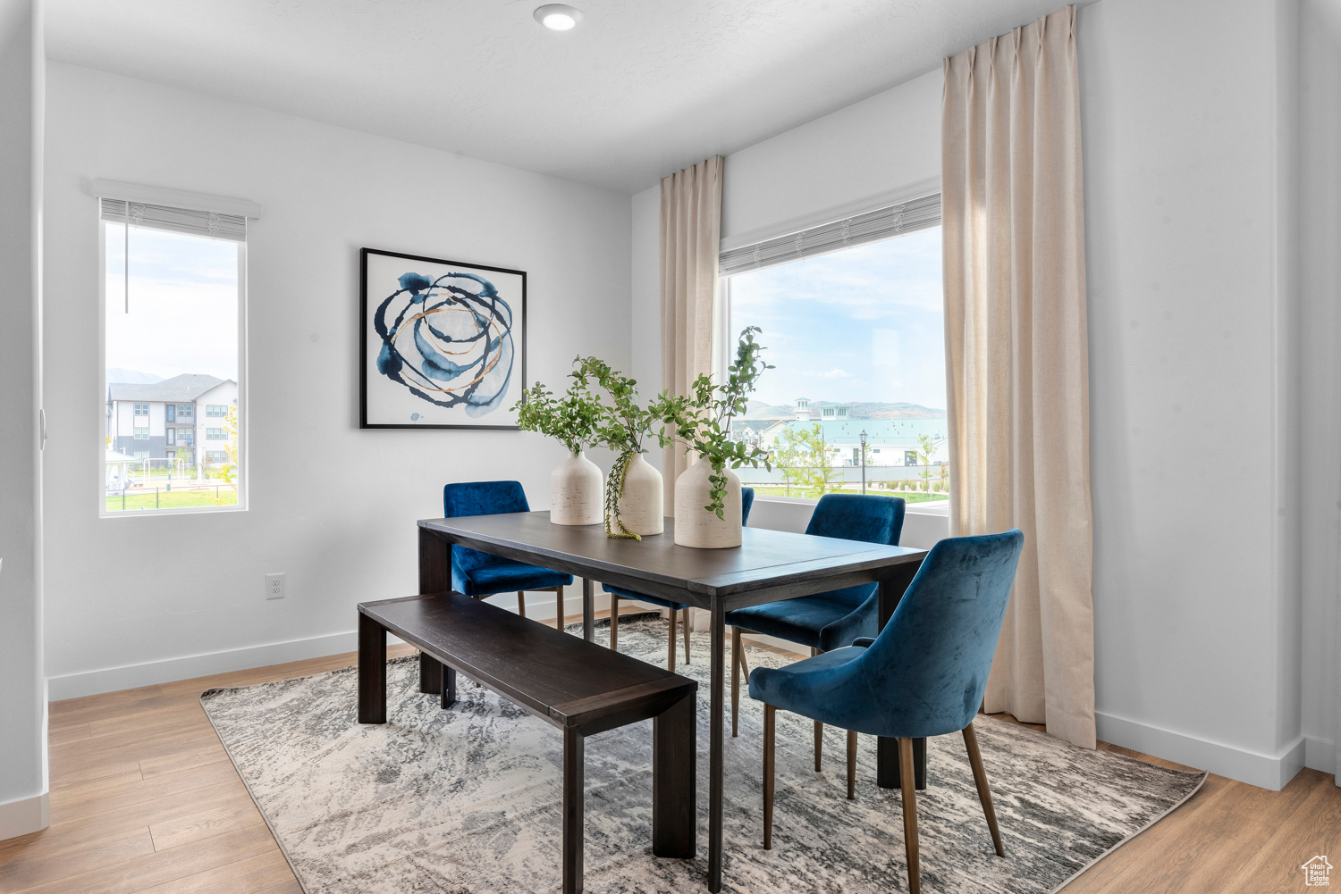 Dining area featuring light wood-style flooring and baseboards