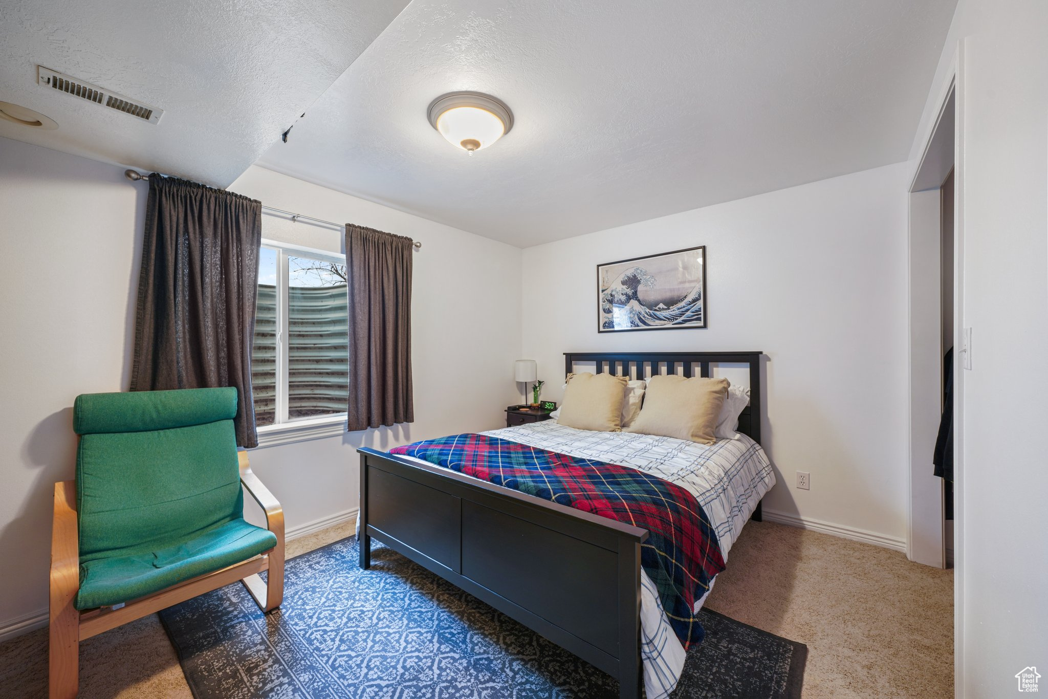 Bedroom with carpet floors, baseboards, and visible vents