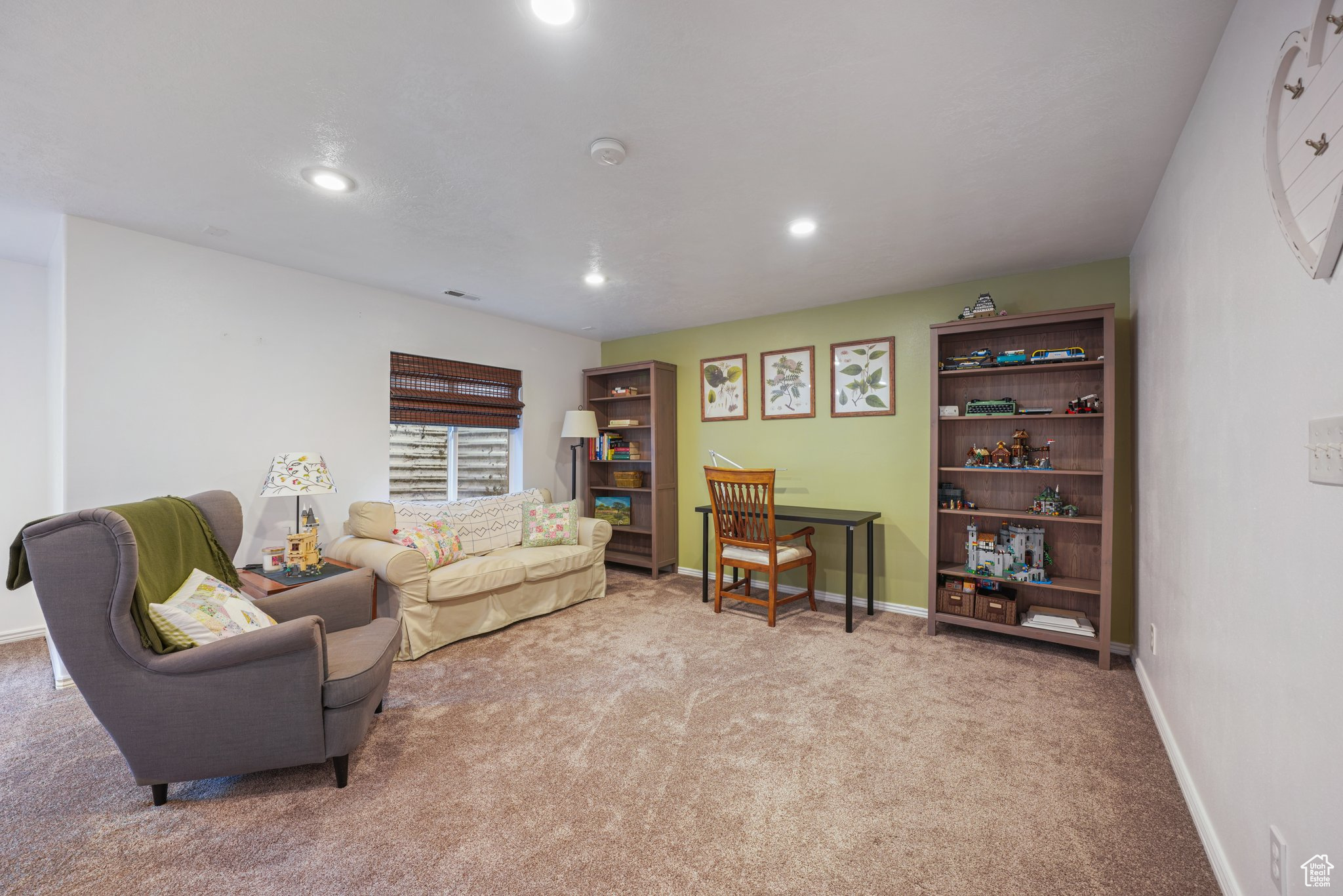 Living room with recessed lighting, light colored carpet, and baseboards