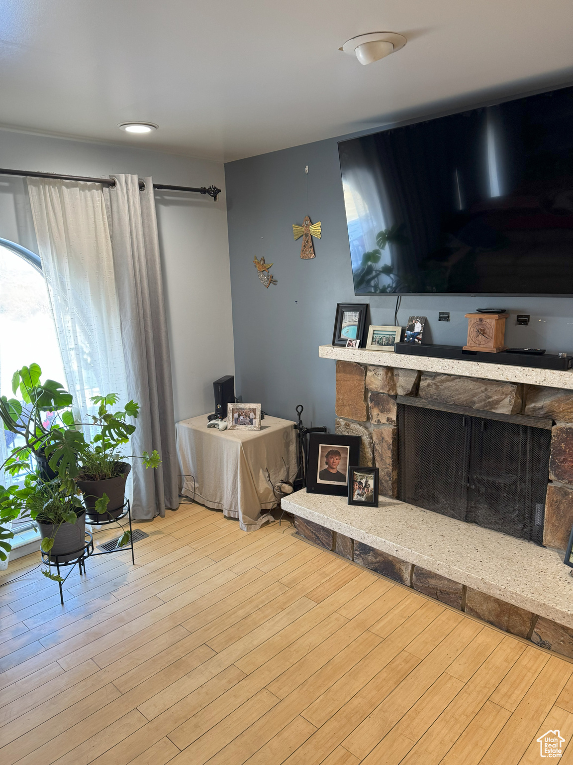 Living area with light wood-type flooring and a fireplace