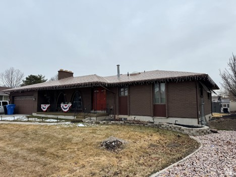 Single story home featuring a front lawn and an attached garage