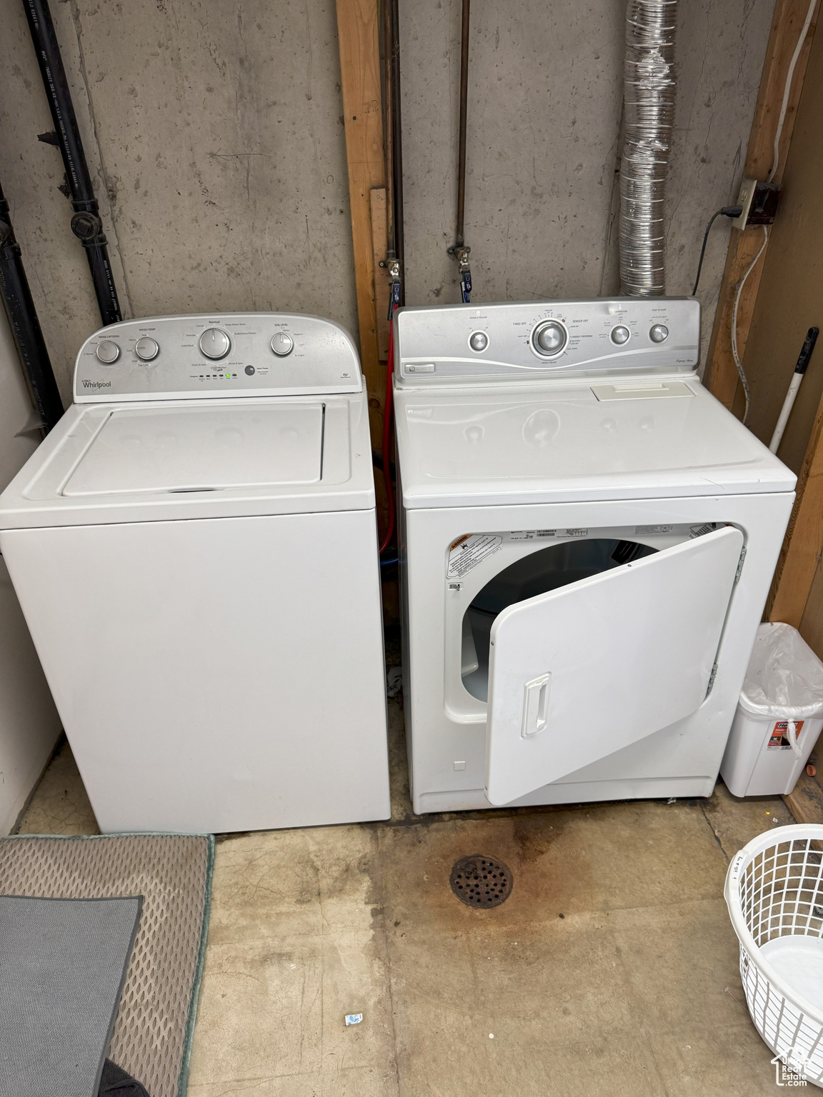 Clothes washing area featuring laundry area and washer and clothes dryer