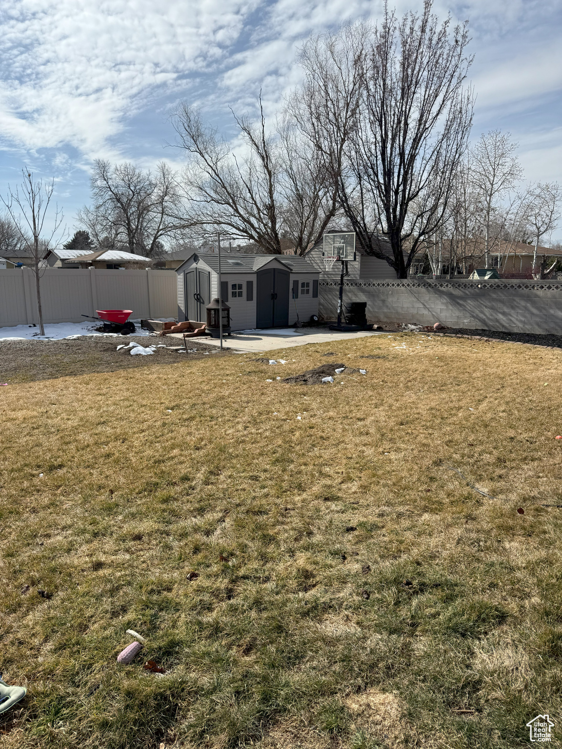 View of yard looking SW, with an outbuilding, fence, and a shed