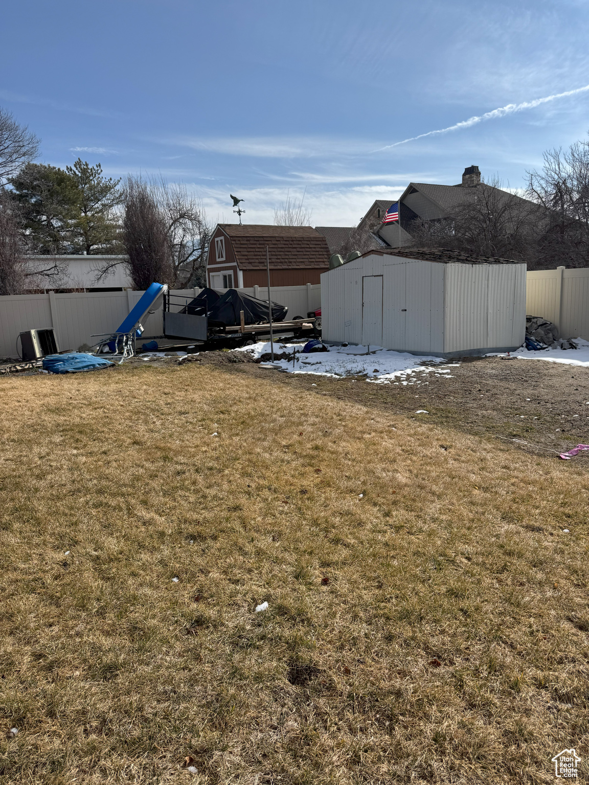 View of yard looking SE, with a shed, an outdoor structure, and fence