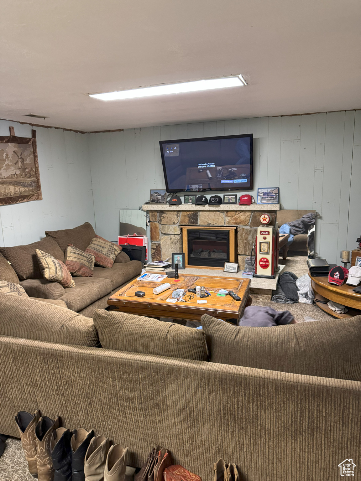 Basement living room featuring a stone fireplace