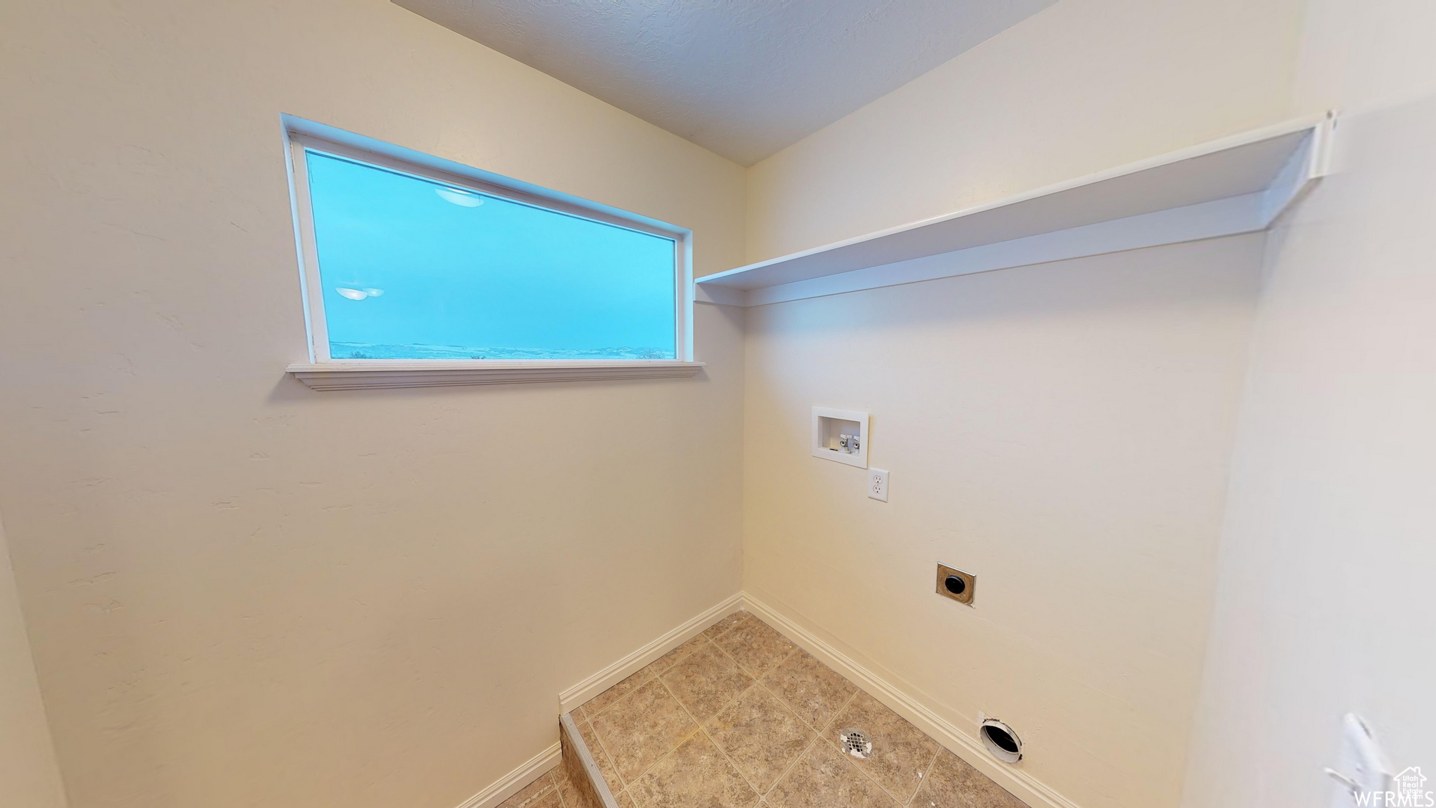 Laundry area with laundry area, baseboards, washer hookup, and hookup for an electric dryer