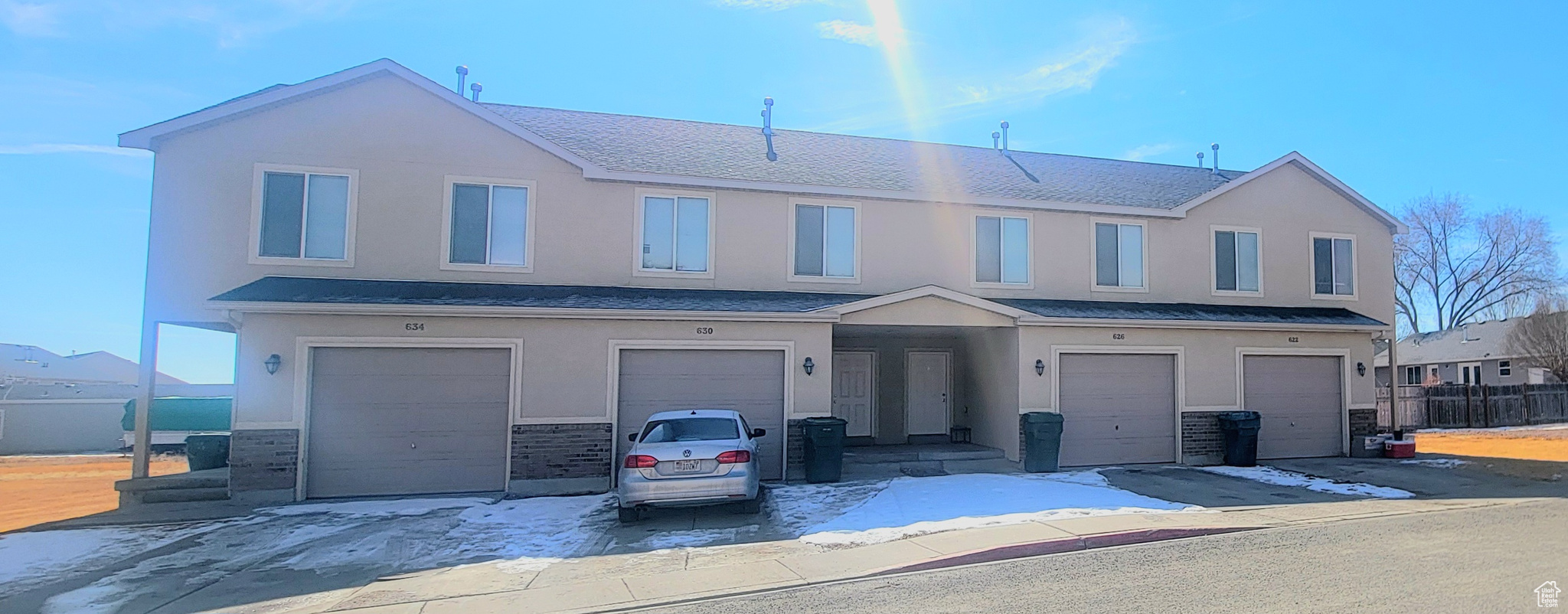 Multi unit property with an attached garage and stucco siding