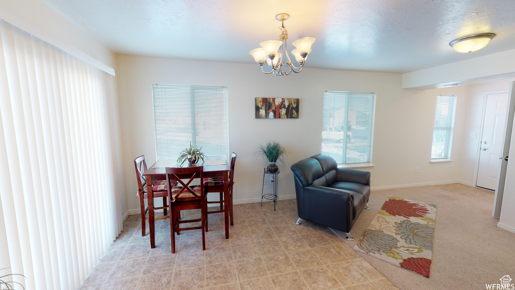 Dining area with a chandelier and baseboards