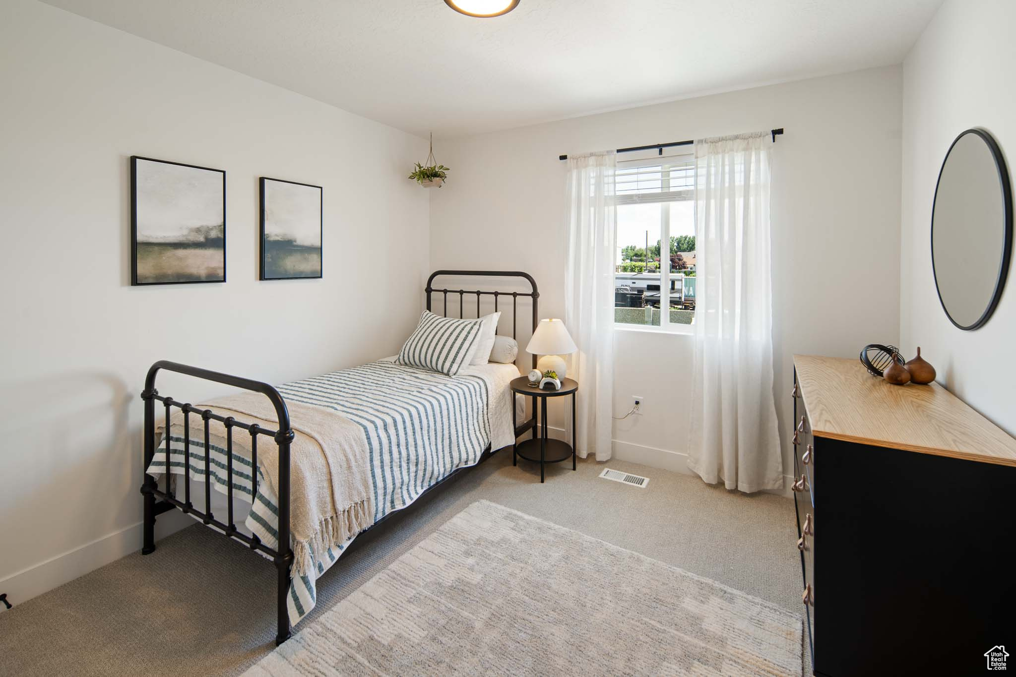 Bedroom with carpet, visible vents, and baseboards