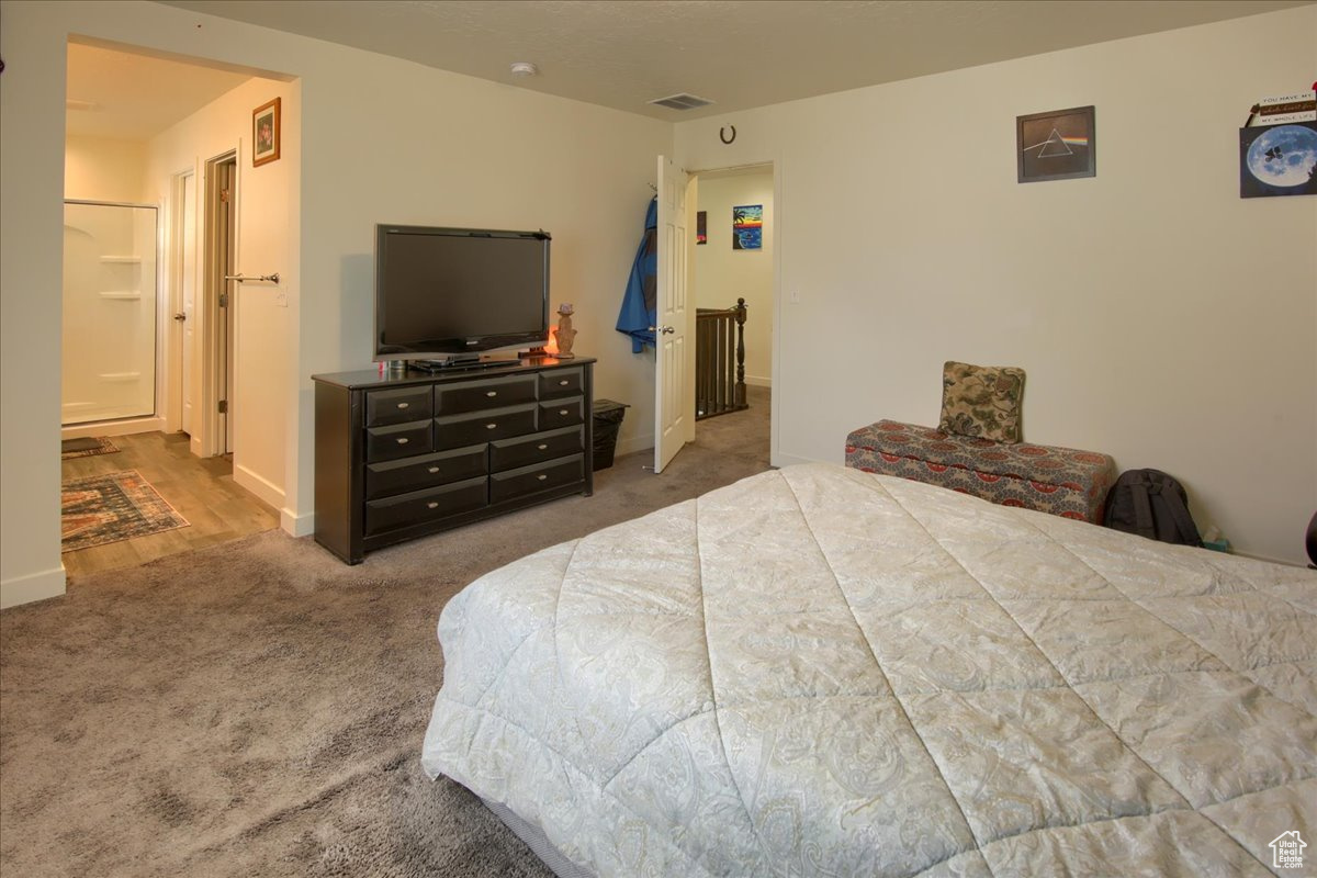 Bedroom featuring carpet, visible vents, and baseboards