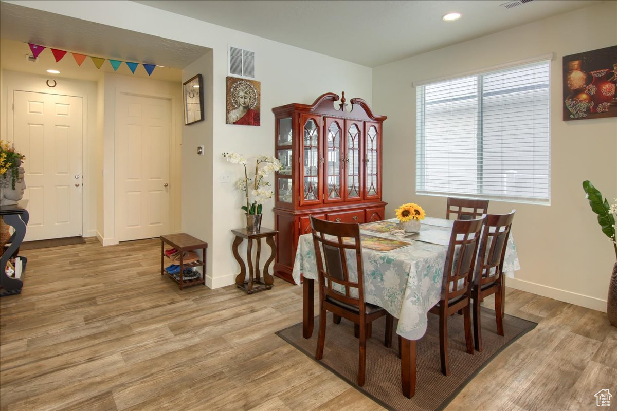 Dining room with recessed lighting, light wood-type flooring, visible vents, and baseboards