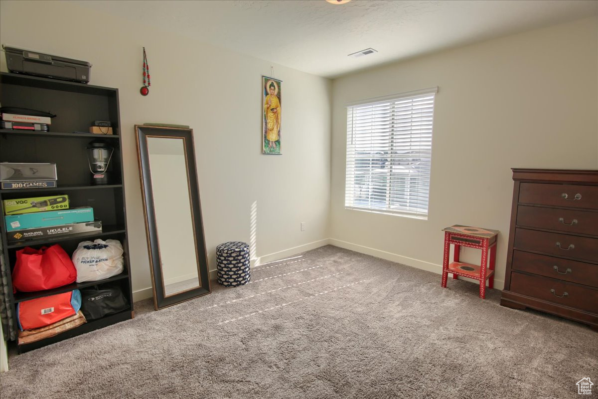 Interior space with light colored carpet and baseboards