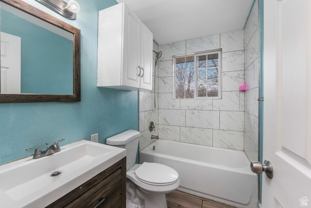 Full bath featuring toilet, tub / shower combination, and vanity