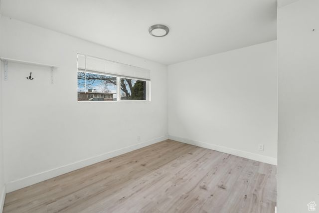 Unfurnished room featuring light wood-type flooring and baseboards