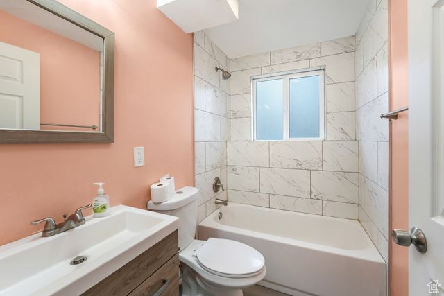 Full bathroom with toilet, shower / tub combination, and vanity