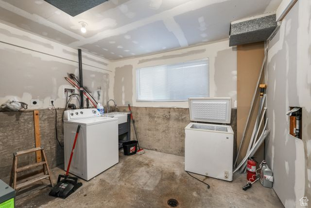 Laundry area with a sink and washing machine and clothes dryer