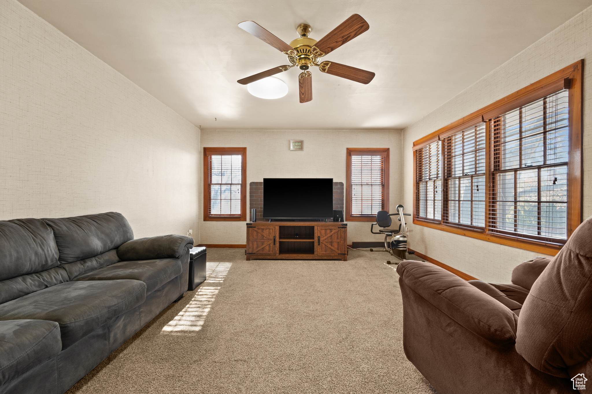 Living room with light carpet and ceiling fan