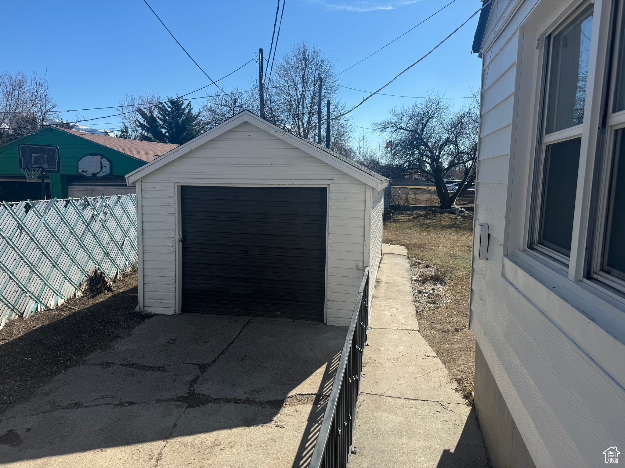 Detached garage with fence and concrete driveway