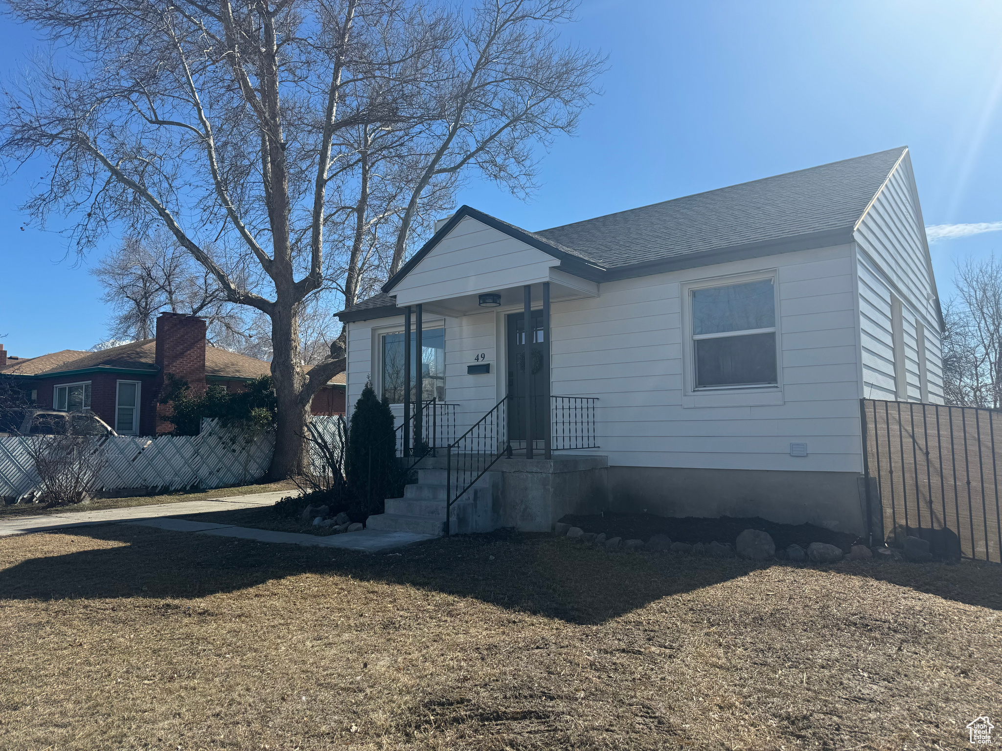 Bungalow-style house with roof with shingles and fence