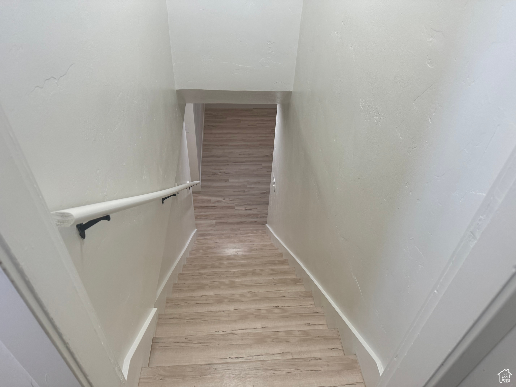 Stairs featuring wood finished floors