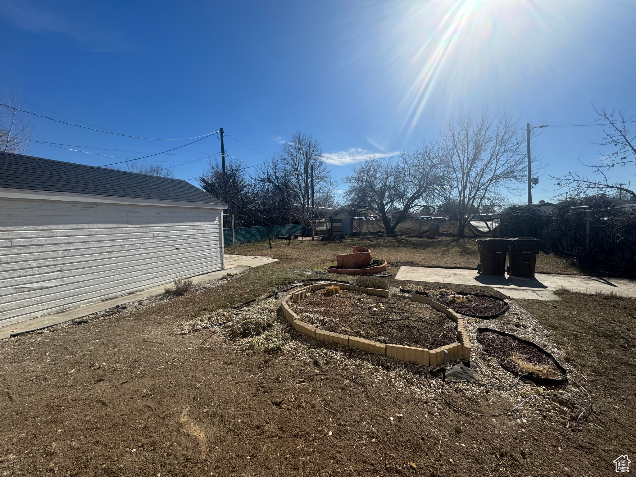 View of yard with a vegetable garden and fence