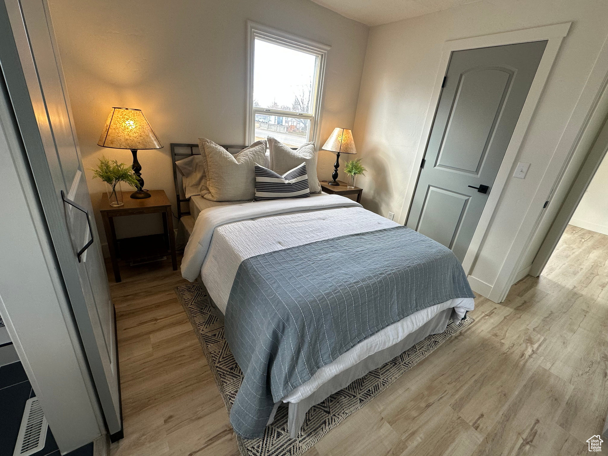 Bedroom featuring light wood-style floors and baseboards