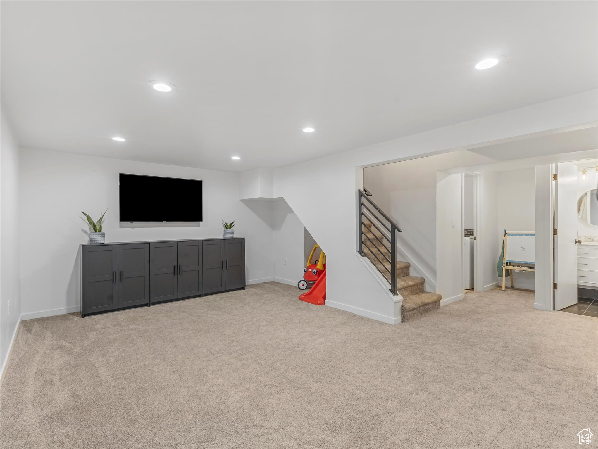 Interior space with recessed lighting, stairs, baseboards, and carpet floors