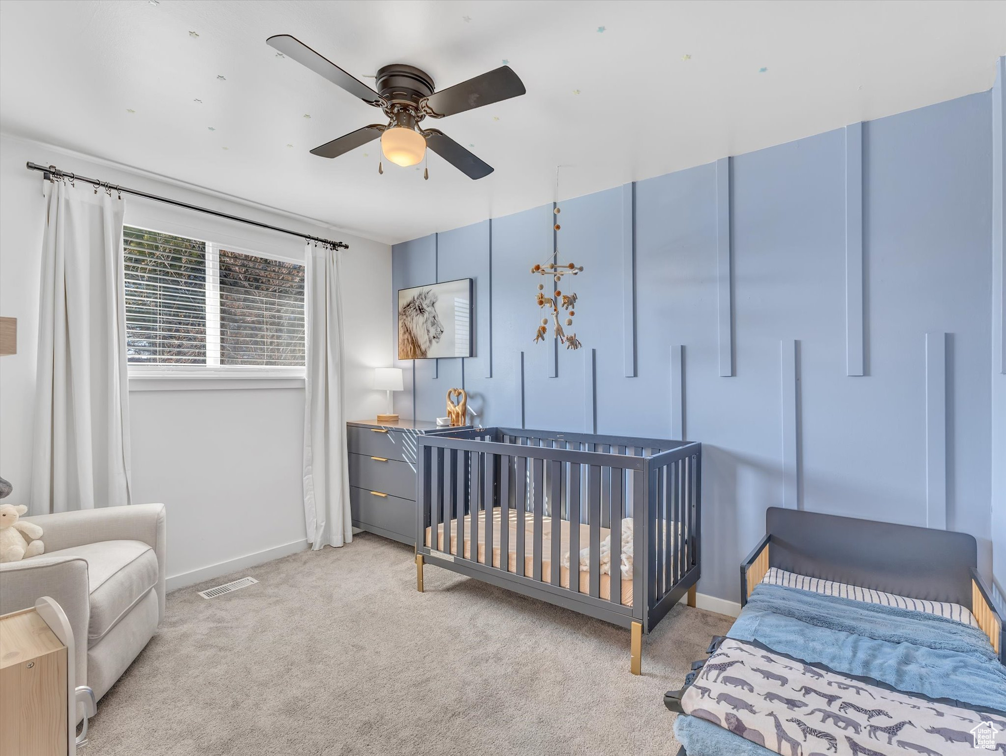 Bedroom featuring baseboards, visible vents, ceiling fan, and light colored carpet