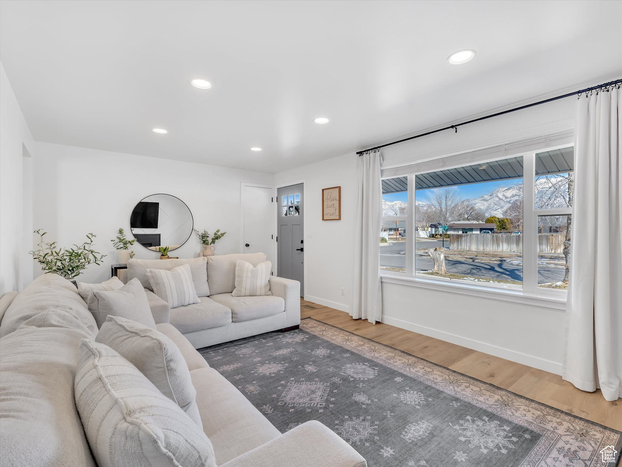 Living room featuring baseboards, wood finished floors, and recessed lighting